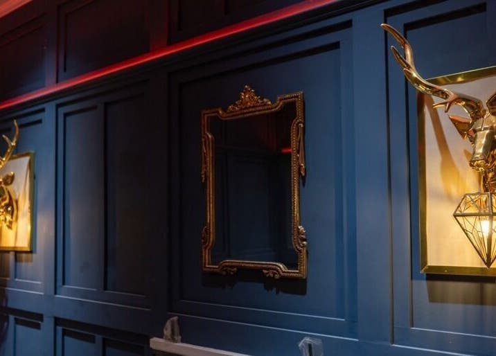 Luxurious decor at The Gorgeous Clinic, Blackpool, England, GB with golden stag heads and ornate mirror.