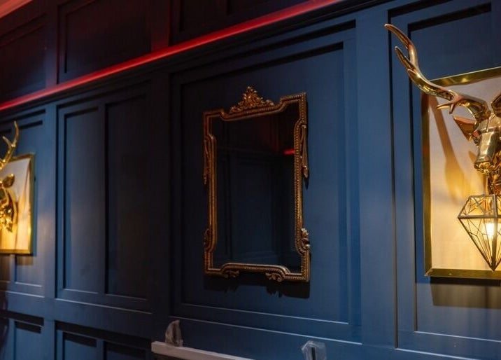 Luxurious decor at The Gorgeous Clinic, Blackpool, England, GB with golden stag heads and ornate mirror.