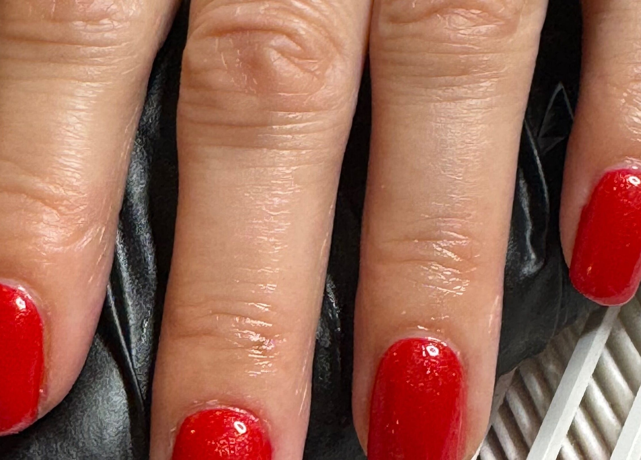 Beautiful red manicure at Gallery of Wellbeing, Hereford, England, GB, showcasing expert nail artistry.