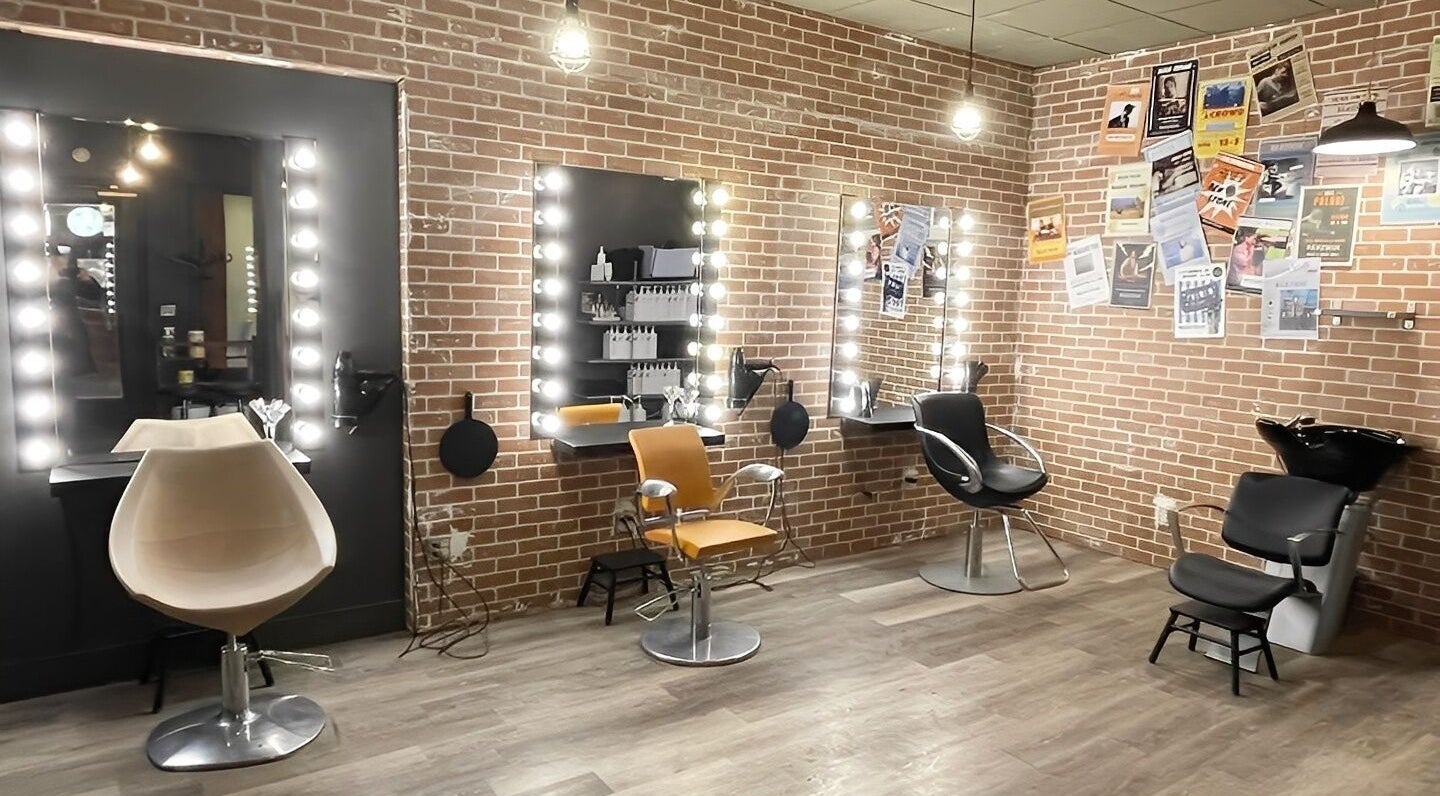 Stylish interior of Beatnik Salon featuring chic chairs and illuminated mirrors in Banff, Alberta, CA.