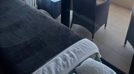 Cozy massage bed beside balcony at Mandurah Mobile Massage Therapy, Mandurah, Western Australia, AU.