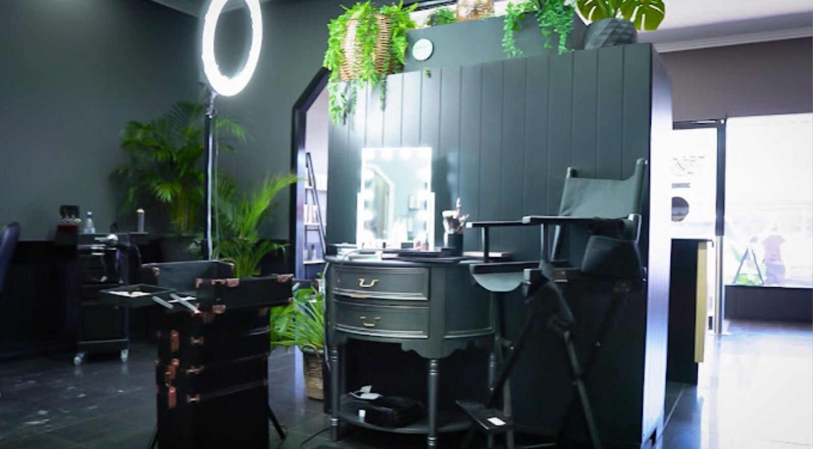 Modern beauty setup at Hair Fx in Roma, Queensland, AU, featuring styling chair and illuminated mirror.