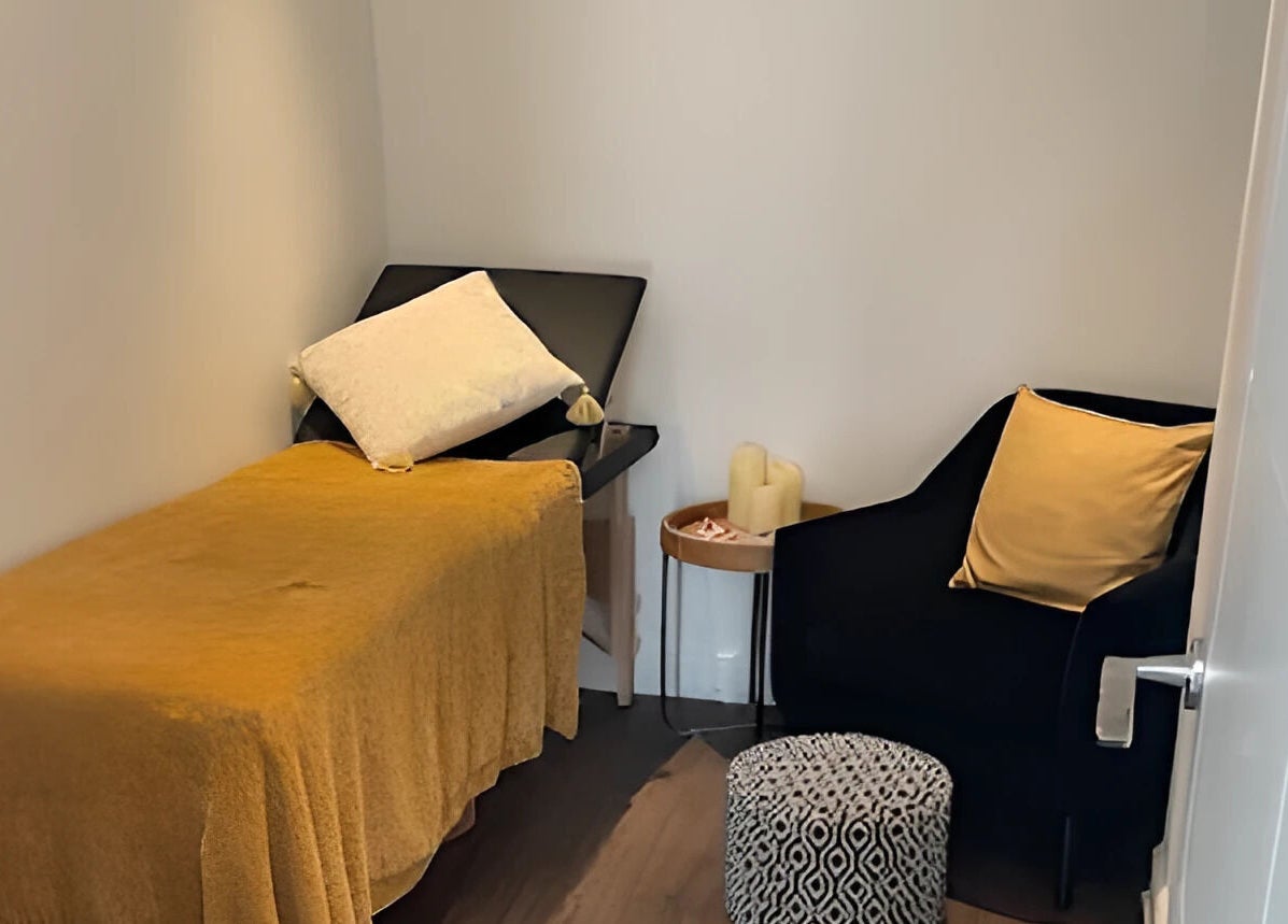 Inviting treatment room at Lisa Lomas Nails and Beauty, Blackpool, England, GB, featuring a plush chair and massage bed.