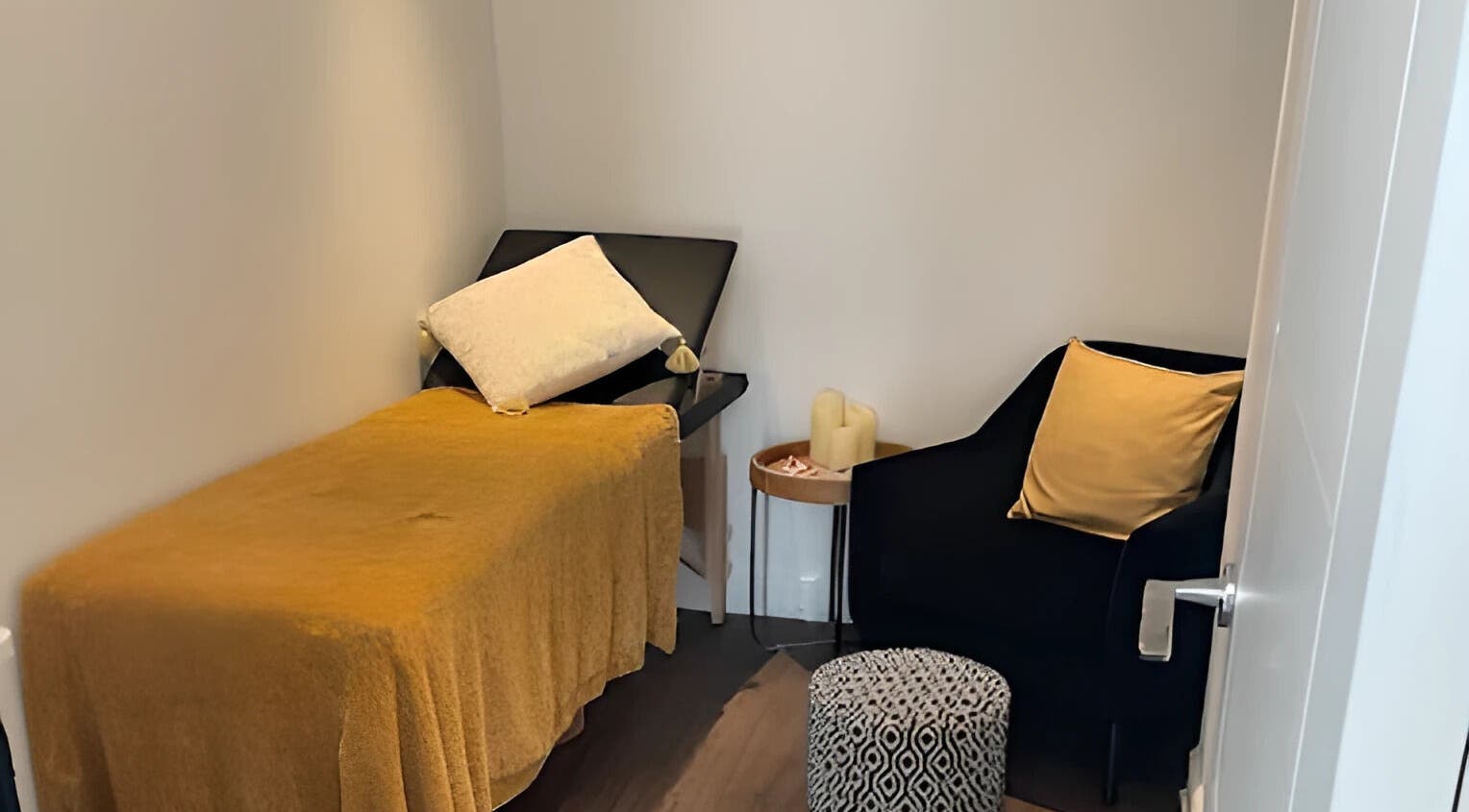 Inviting treatment room at Lisa Lomas Nails and Beauty, Blackpool, England, GB, featuring a plush chair and massage bed.