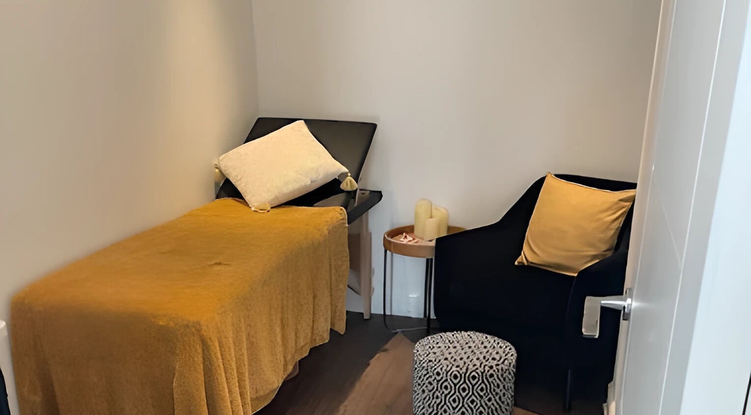 Inviting treatment room at Lisa Lomas Nails and Beauty, Blackpool, England, GB, featuring a plush chair and massage bed.