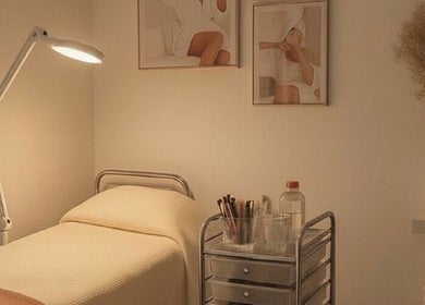 Serene spa room at Club Love Yourself, London, England, GB, featuring a cozy bed and soft lighting.