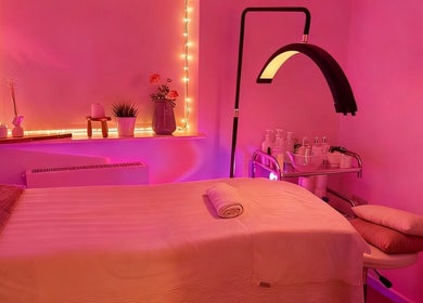 Serene massage room at Club Love Yourself, London, England, GB, with soft lighting and cozy decor.
