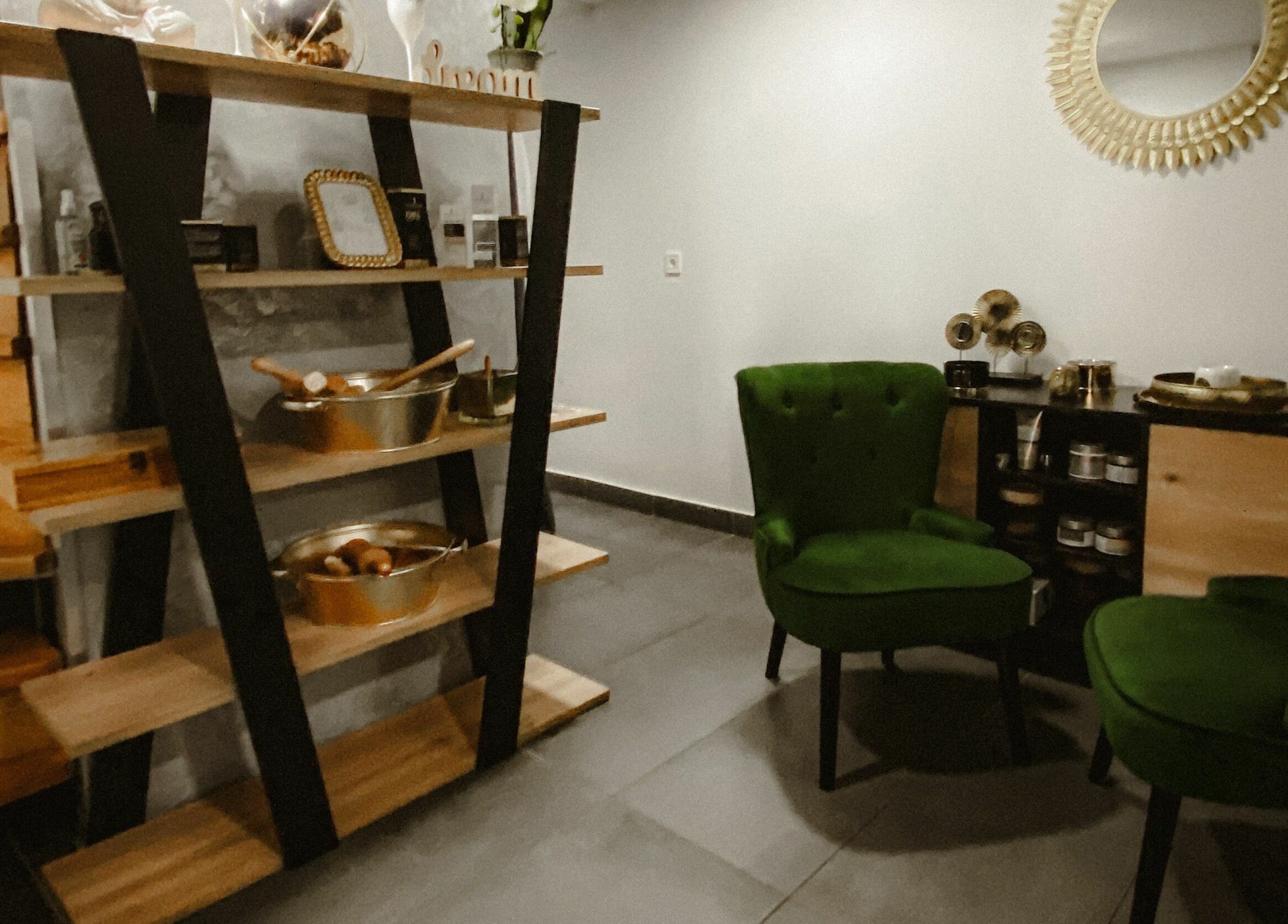 Relaxing seating area in Classics of Massage Spa, Dubrovnik, HR with green chairs near stylish decor.