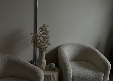 Elegant lounge area at LJW Brows in Stoke-on-Trent, England, GB, featuring plush chairs and tasteful decor.