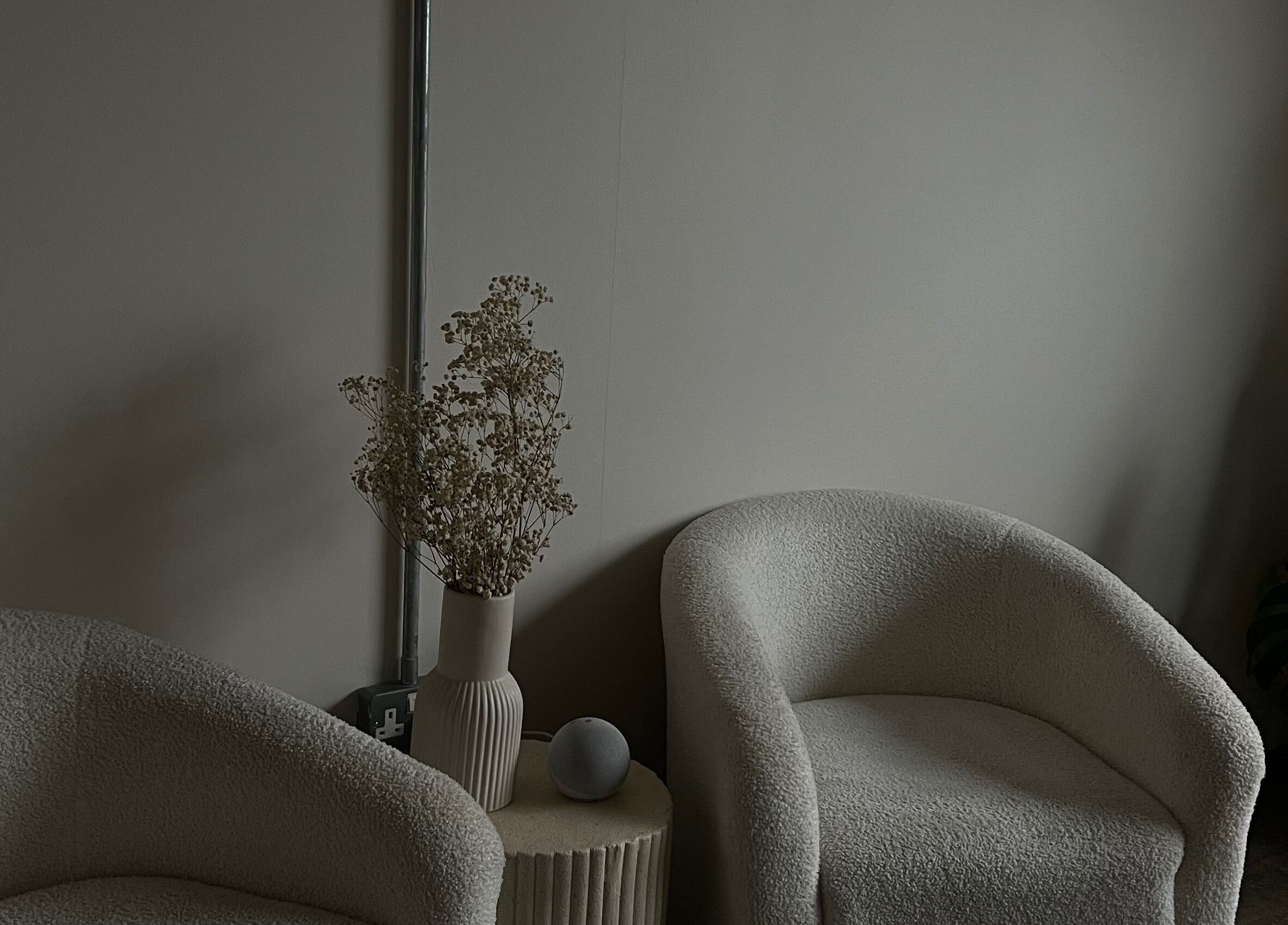 Elegant lounge area at LJW Brows in Stoke-on-Trent, England, GB, featuring plush chairs and tasteful decor.