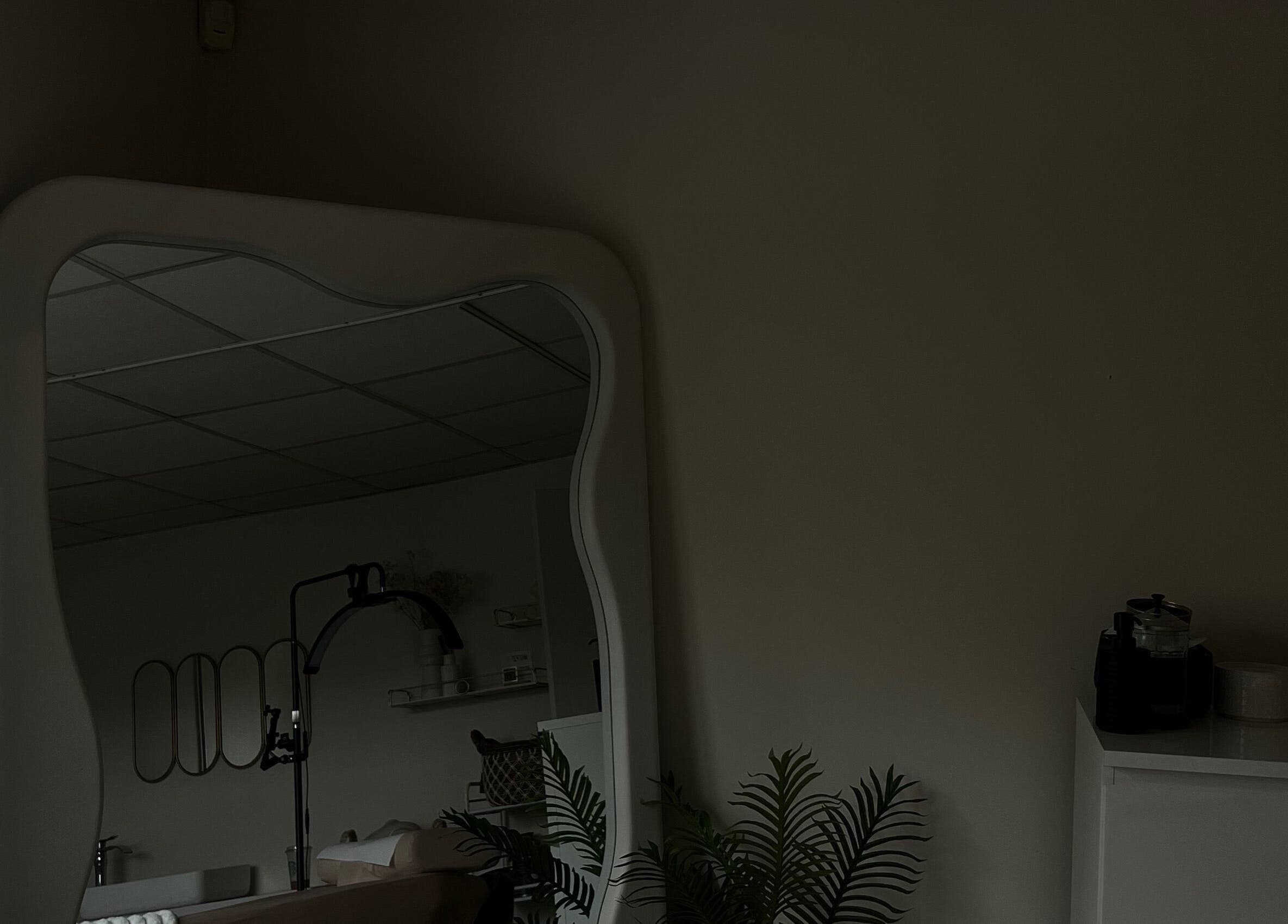 Spacious interior of LJW Brows, Stoke-on-Trent, England, GB, featuring a stylish large mirror and elegant decor.