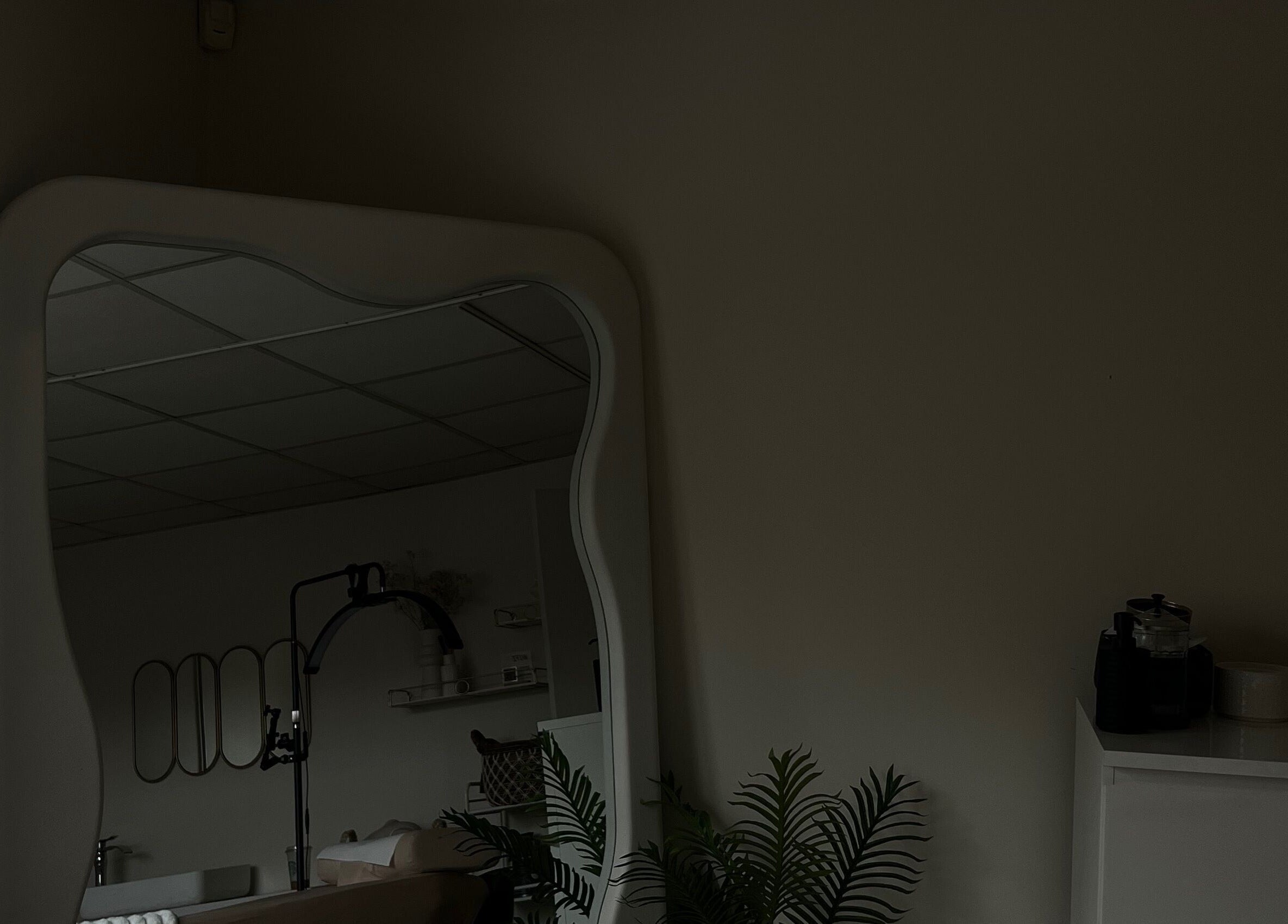 Spacious interior of LJW Brows, Stoke-on-Trent, England, GB, featuring a stylish large mirror and elegant decor.