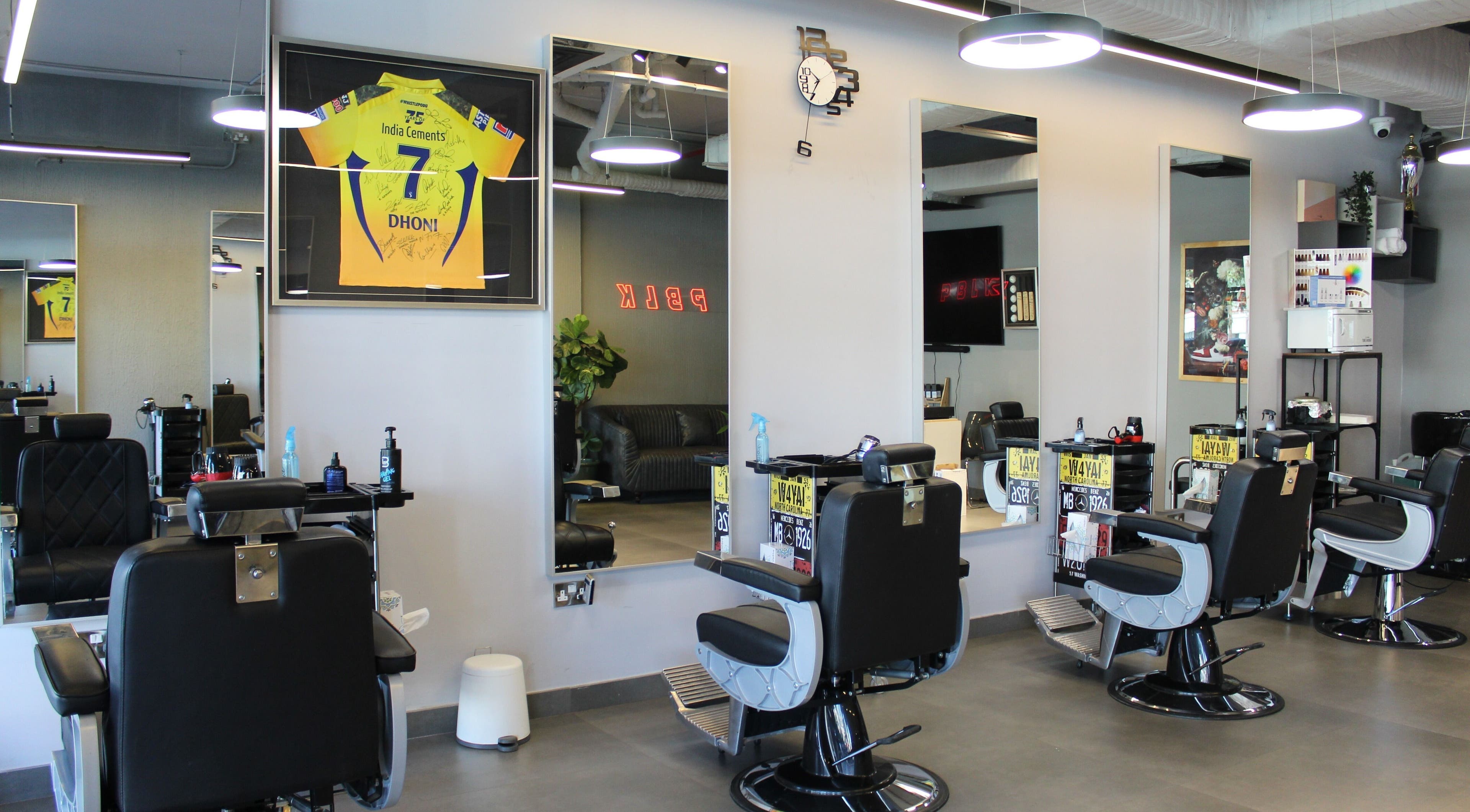 Modern interior of Evoke Gents Saloon in Dubai, AE featuring sleek barber chairs and stylish decor.