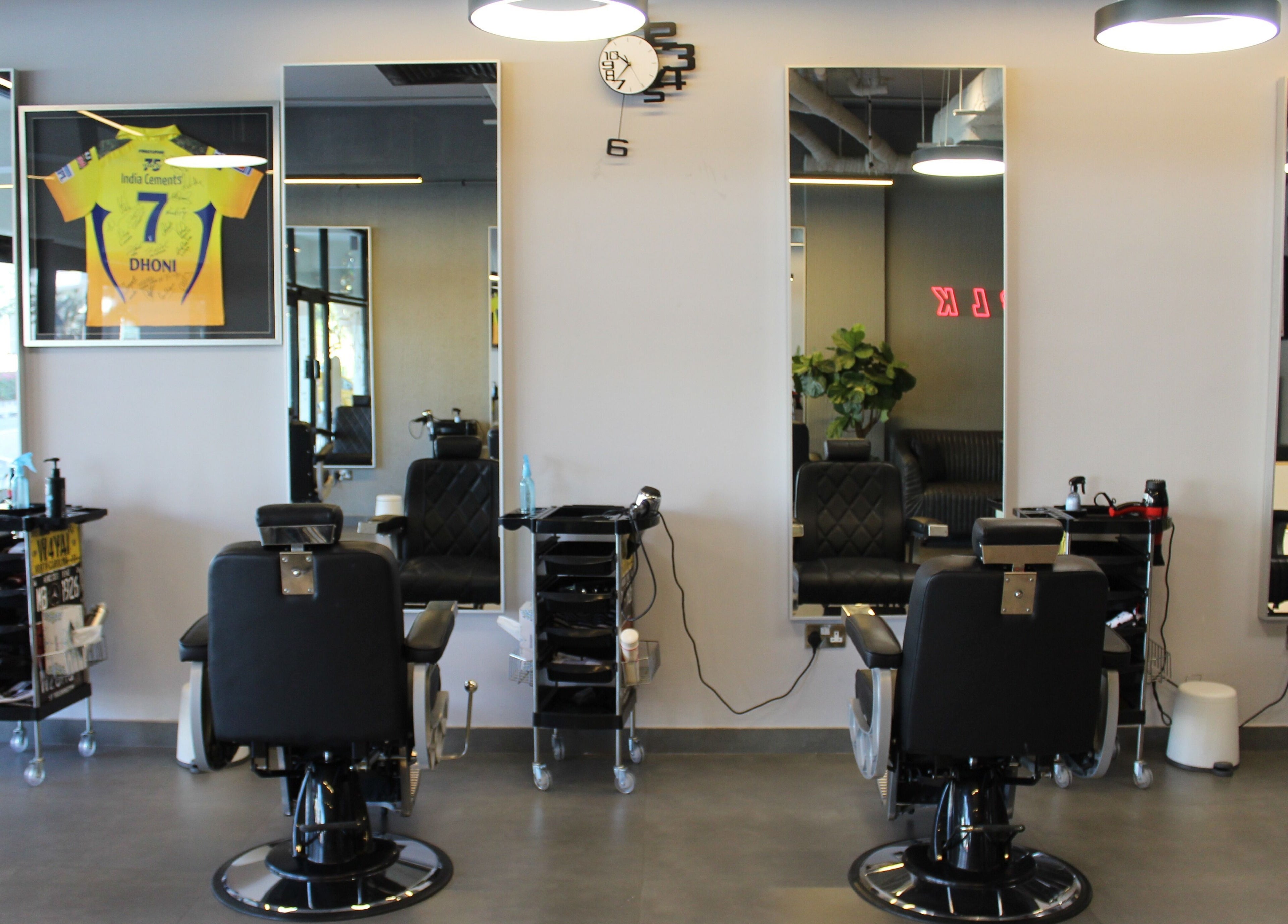 Evoke Gents Saloon interior with sleek chairs and mirrors, Dubai, AE offering modern grooming services.