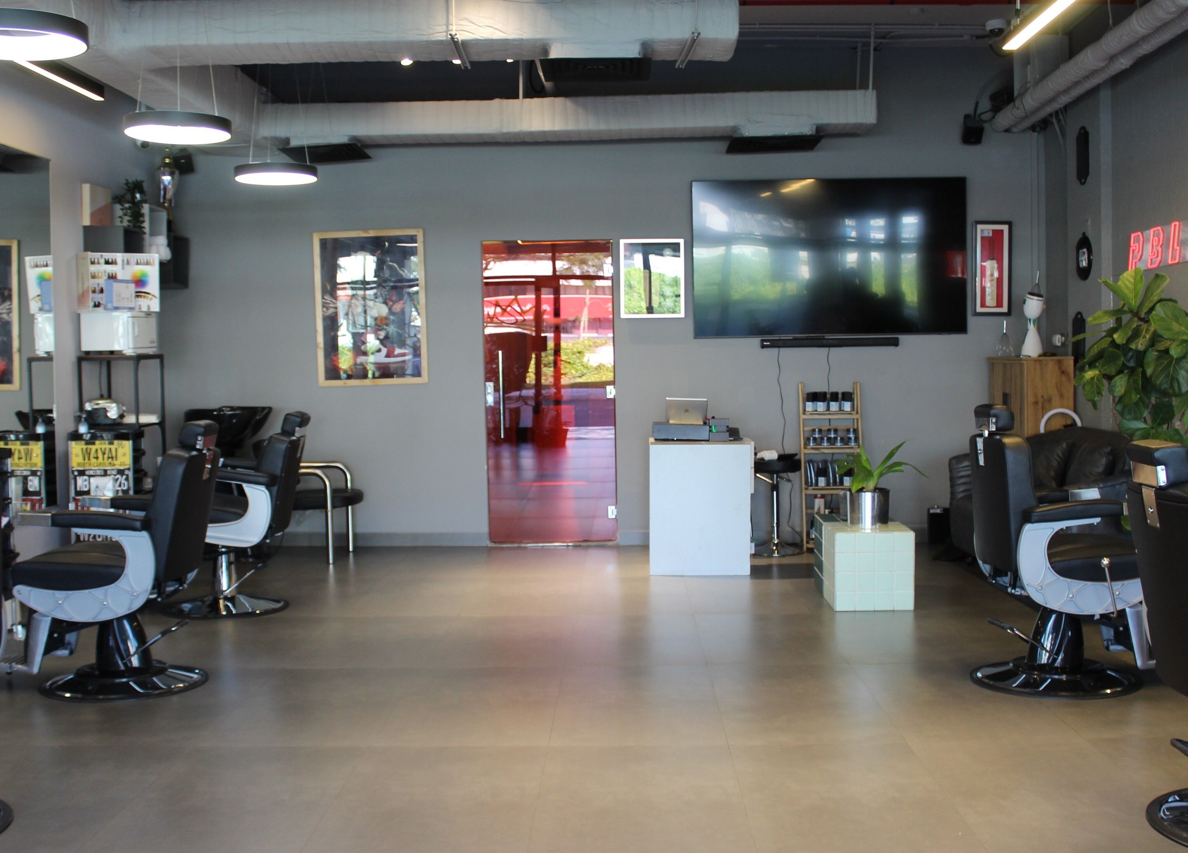 Stylish interior of Evoke Gents Saloon, Dubai, AE showcasing modern barber chairs and decor.