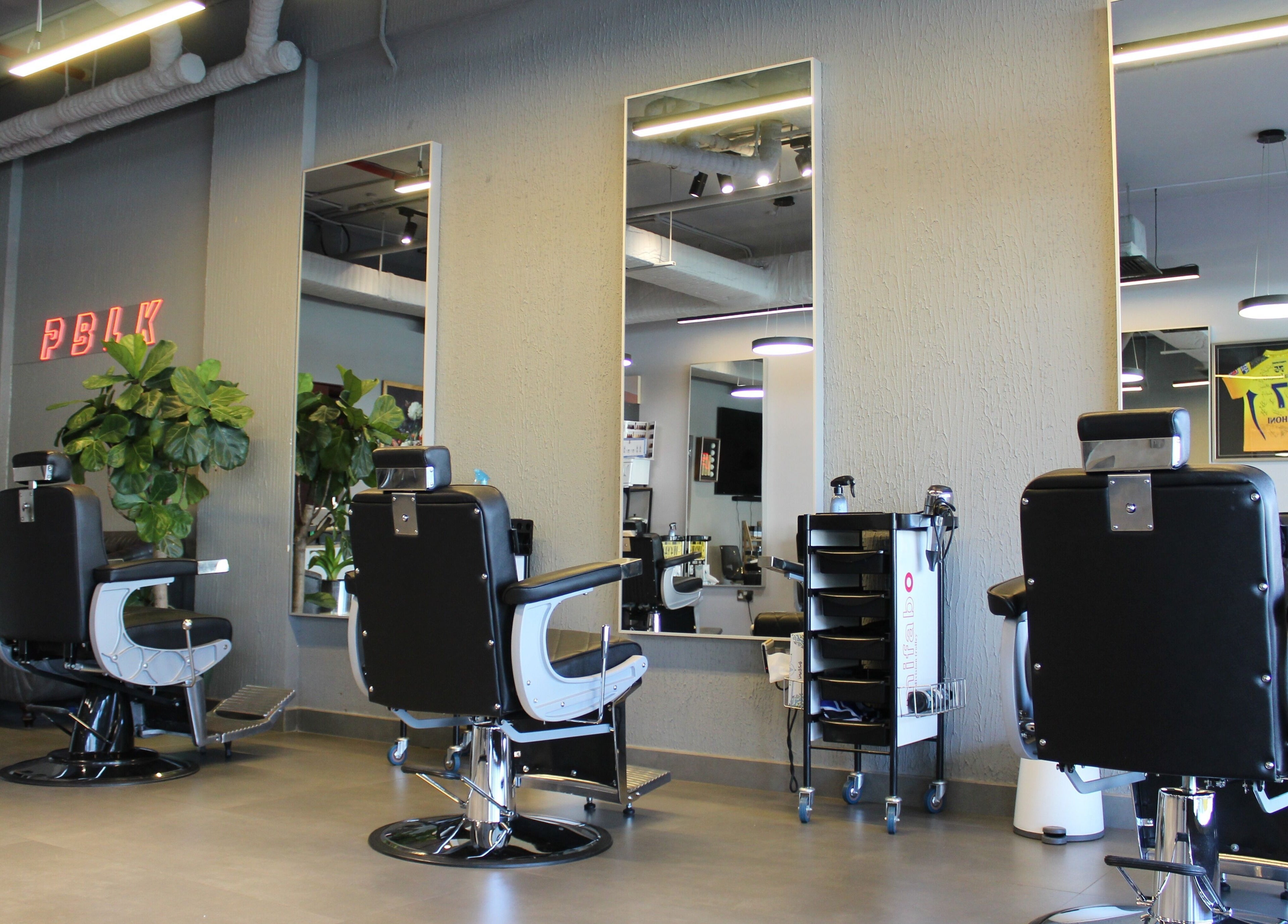 Modern salon chairs at Evoke Gents Saloon, Dubai, AE, offering a stylish and comfortable grooming experience.