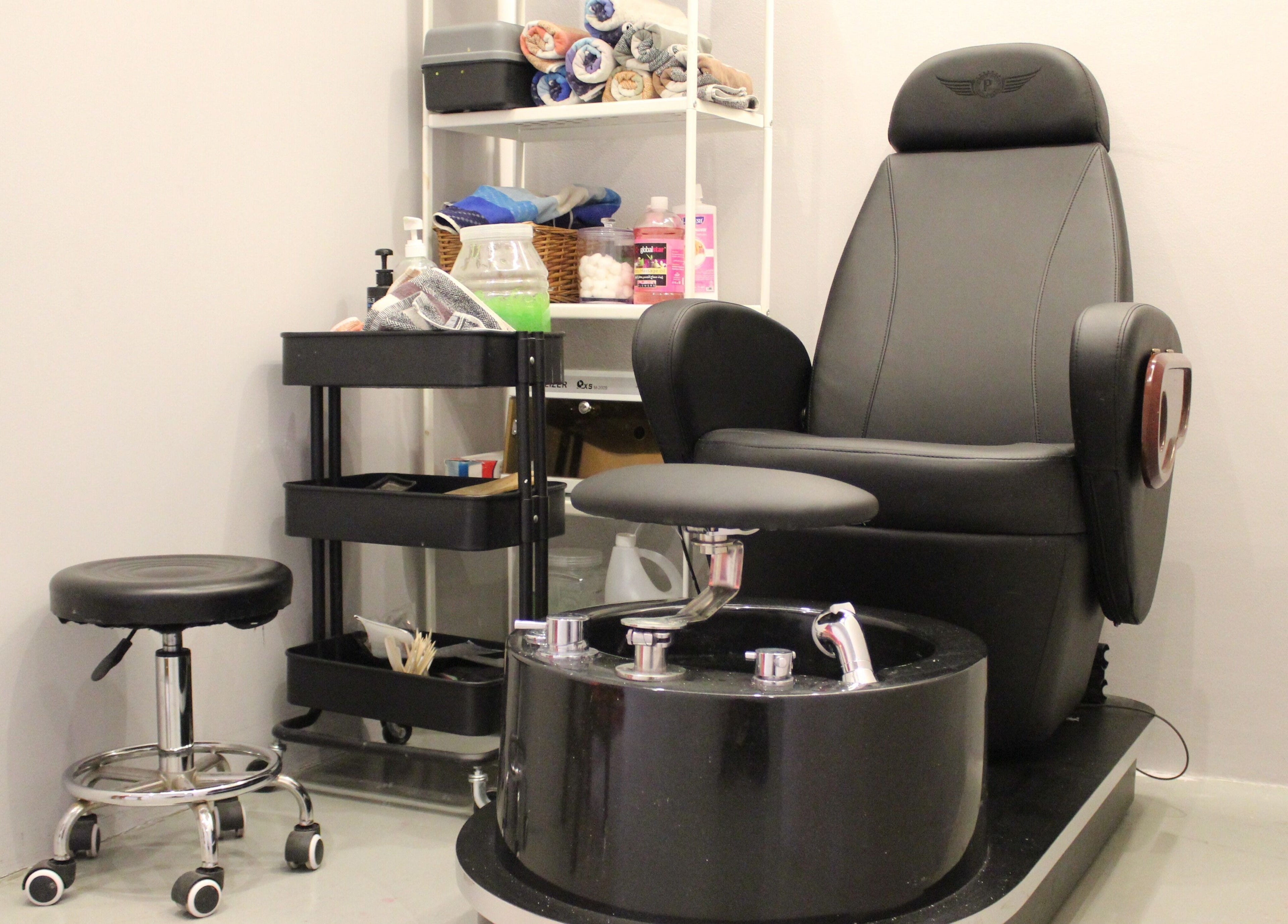 Pedicure chair in Evoke Gents Saloon, Dubai, AE, showcasing comfort and elegance.