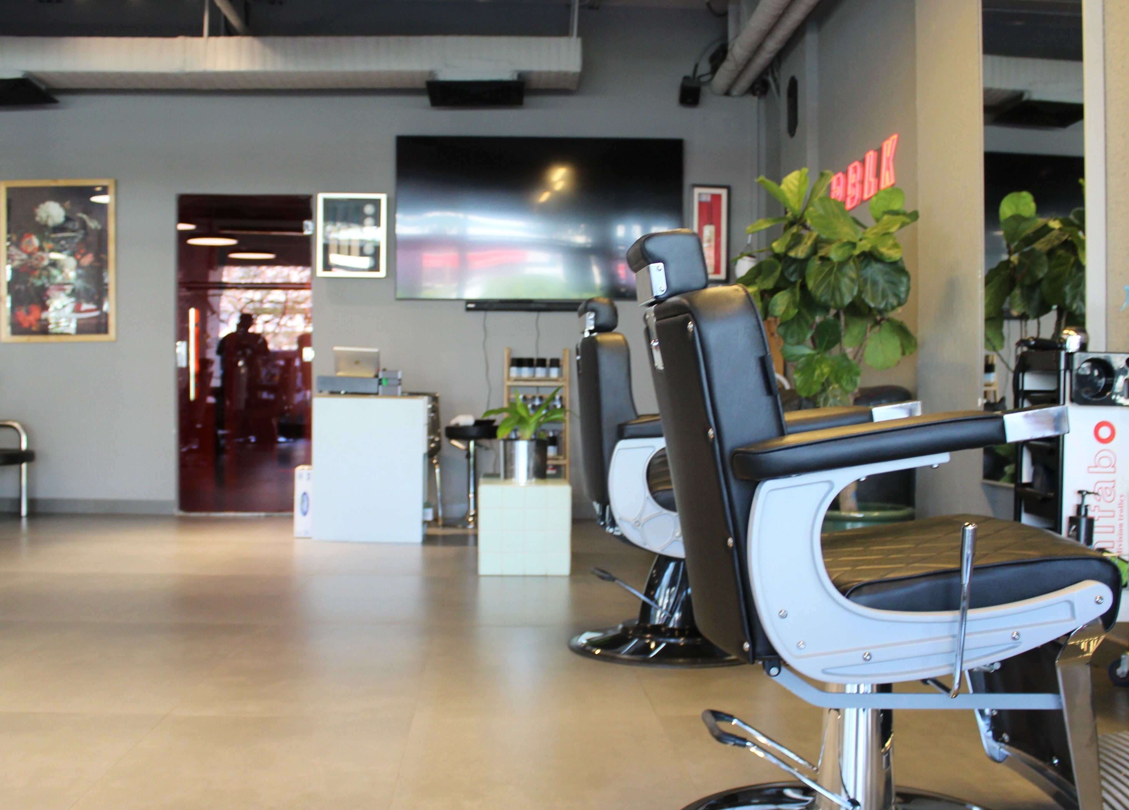Interior of Evoke Gents Saloon in Dubai, AE, showcasing sleek barber chairs and modern decor.