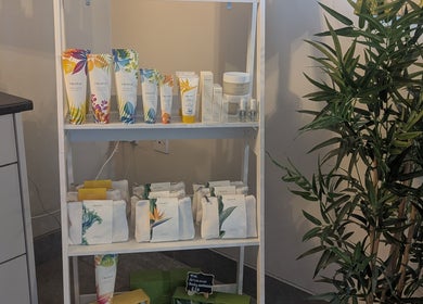 Product shelf at The Beauty Barn at Pinwall, Atherstone, England, GB with tropical-themed items.