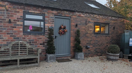 Charming entrance of The Beauty Barn at Pinwall with rustic decor in Atherstone, England, GB.