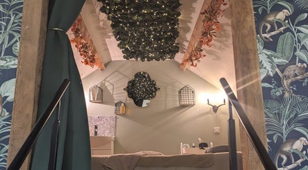 Chic, tranquil room at The Beauty Barn at Pinwall, Atherstone, England, GB with leafy decor and ambient lighting.