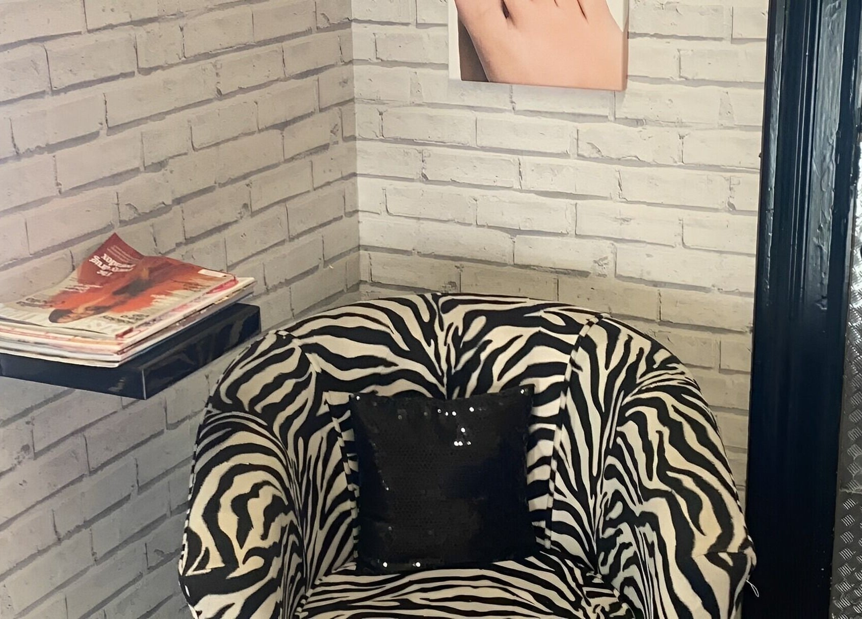 Chic zebra-print chair and magazines at The Nail Studio, Stratford-upon-Avon, England, GB.