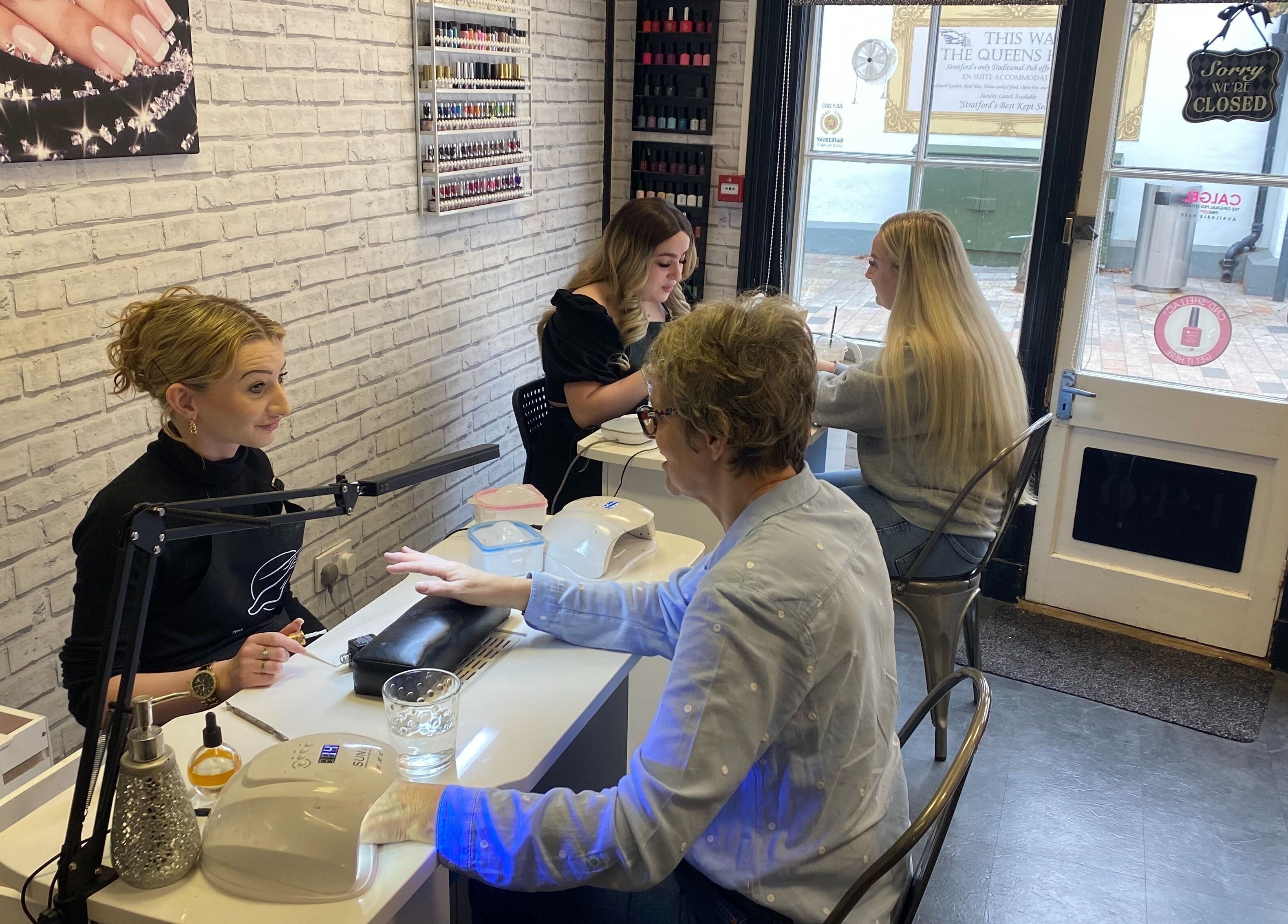 Customers enjoying nail services at The Nail Studio, Stratford-upon-Avon, England, GB.