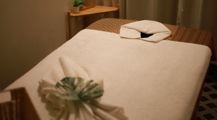 Massage table at Thanwa Thai Massage, Melbourne, Victoria, AU, with soft white towels and serene decor.