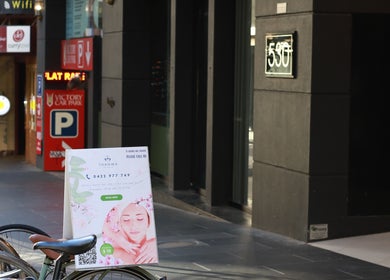 Thanwa Thai Massage entrance sign on a bustling street in Melbourne, Victoria, AU.