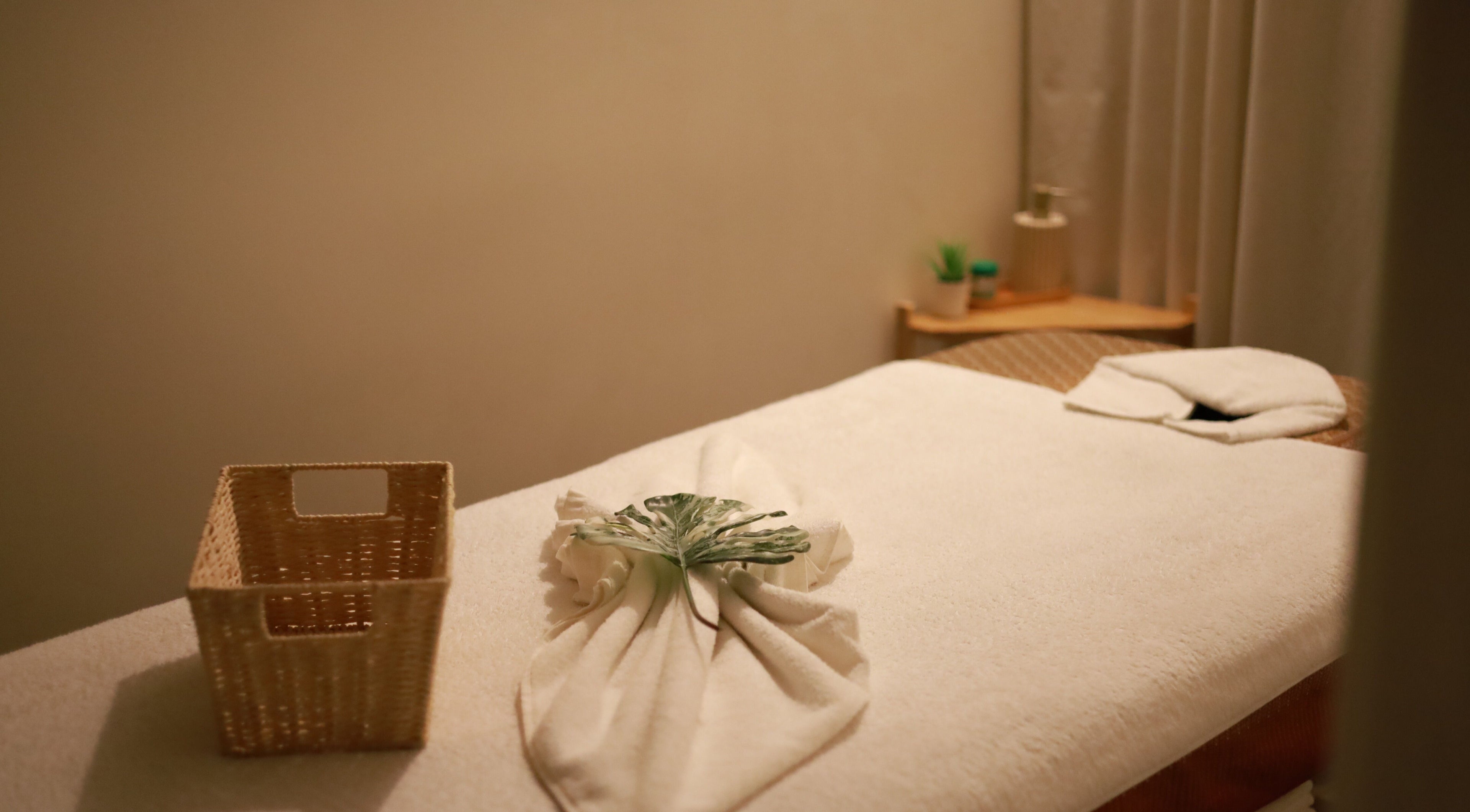 Tranquil massage room at Thanwa Thai Massage, Melbourne, Victoria, AU, featuring a neatly arranged treatment bed.