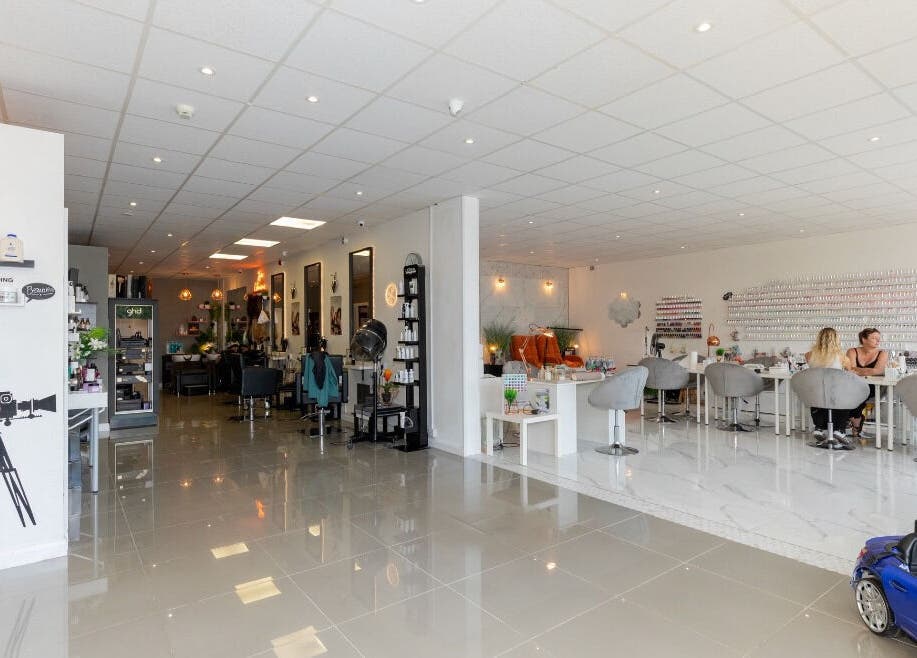 Gorgeous salon interior with modern design in Wolverhampton, England, GB; featuring nail care and styling areas.