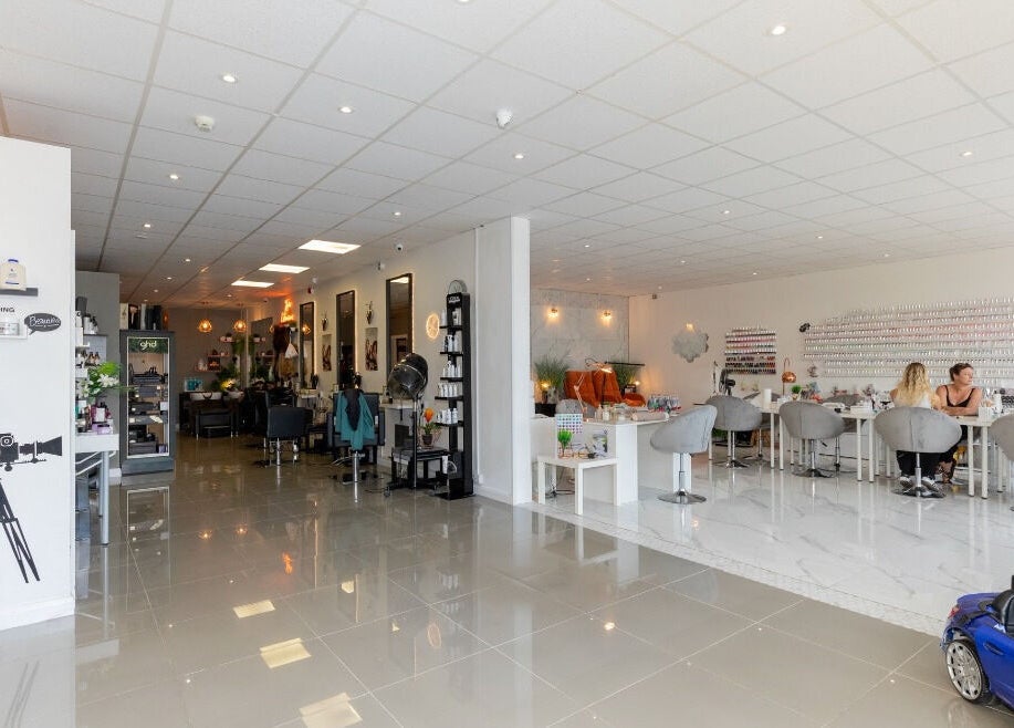 Gorgeous salon interior with modern design in Wolverhampton, England, GB; featuring nail care and styling areas.