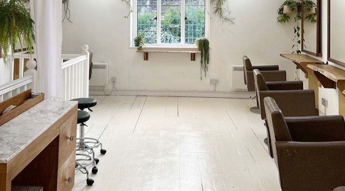 Spacious interior of The Hairdresser at The Studio, 1 Vicarage Street, Frome, featuring modern salon chairs.