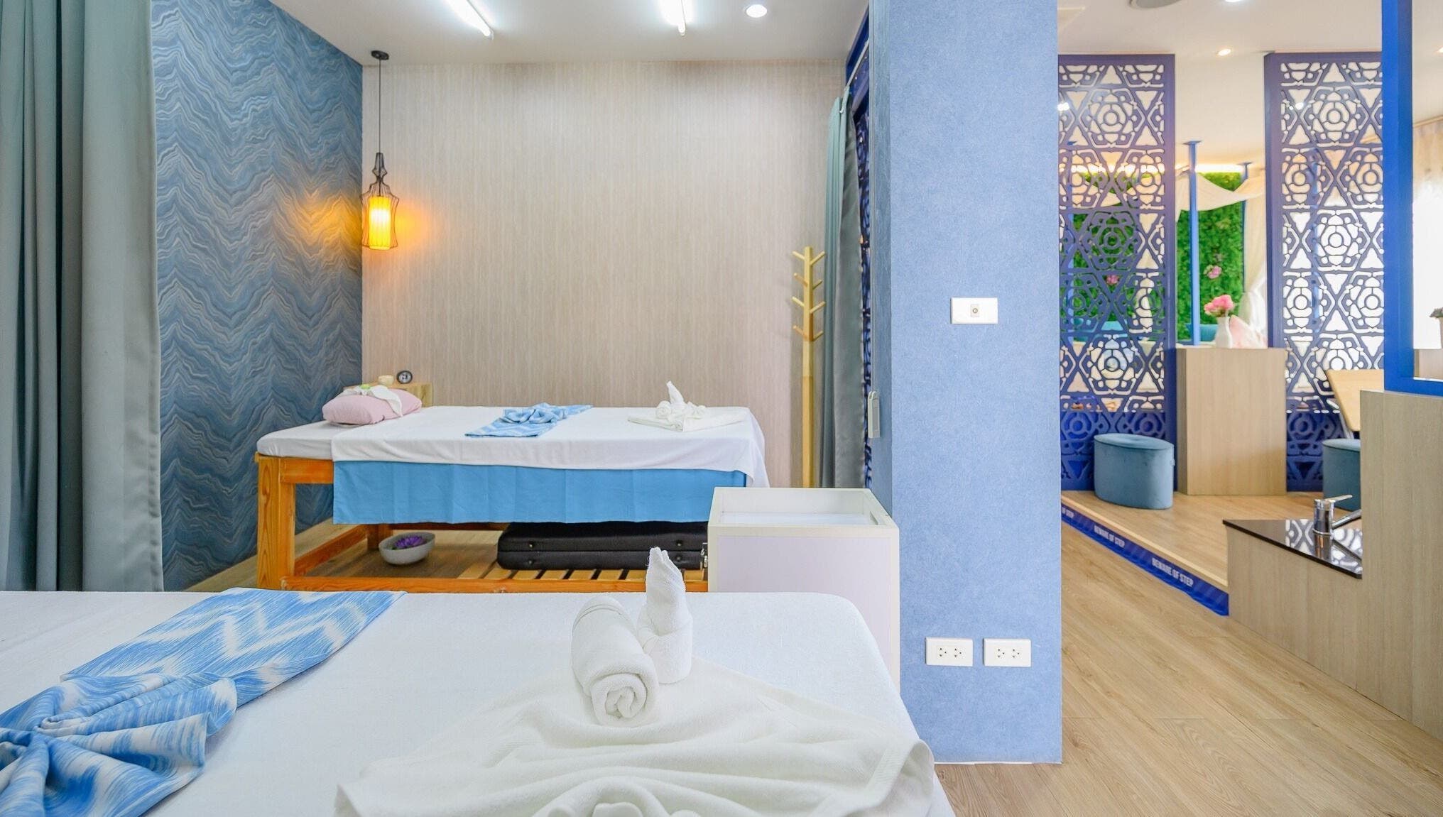 Relaxing massage room at Apsara Spa, Tambon Choeng Thale, Phuket, TH showcasing luxurious treatment beds.