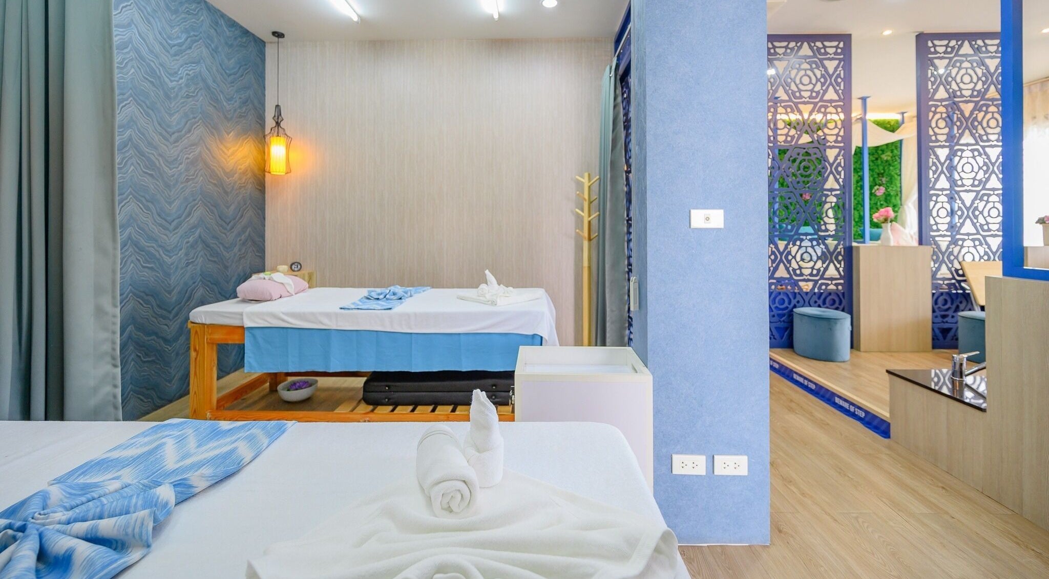 Relaxing massage room at Apsara Spa, Tambon Choeng Thale, Phuket, TH showcasing luxurious treatment beds.