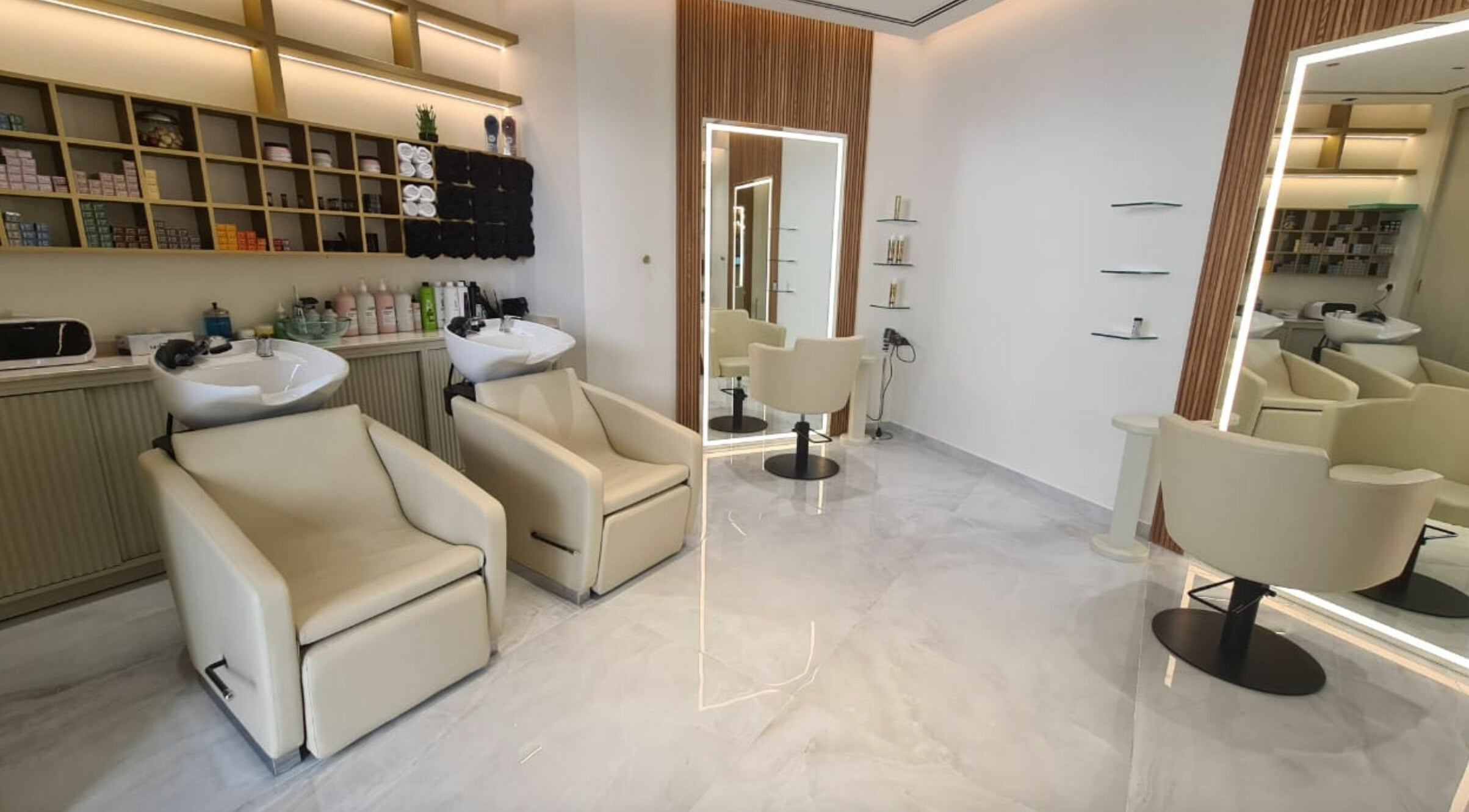 Elegant interior of Fadi Rashwani Boutique Beauty Salon, Dubai, AE showcasing modern salon chairs and mirrors.