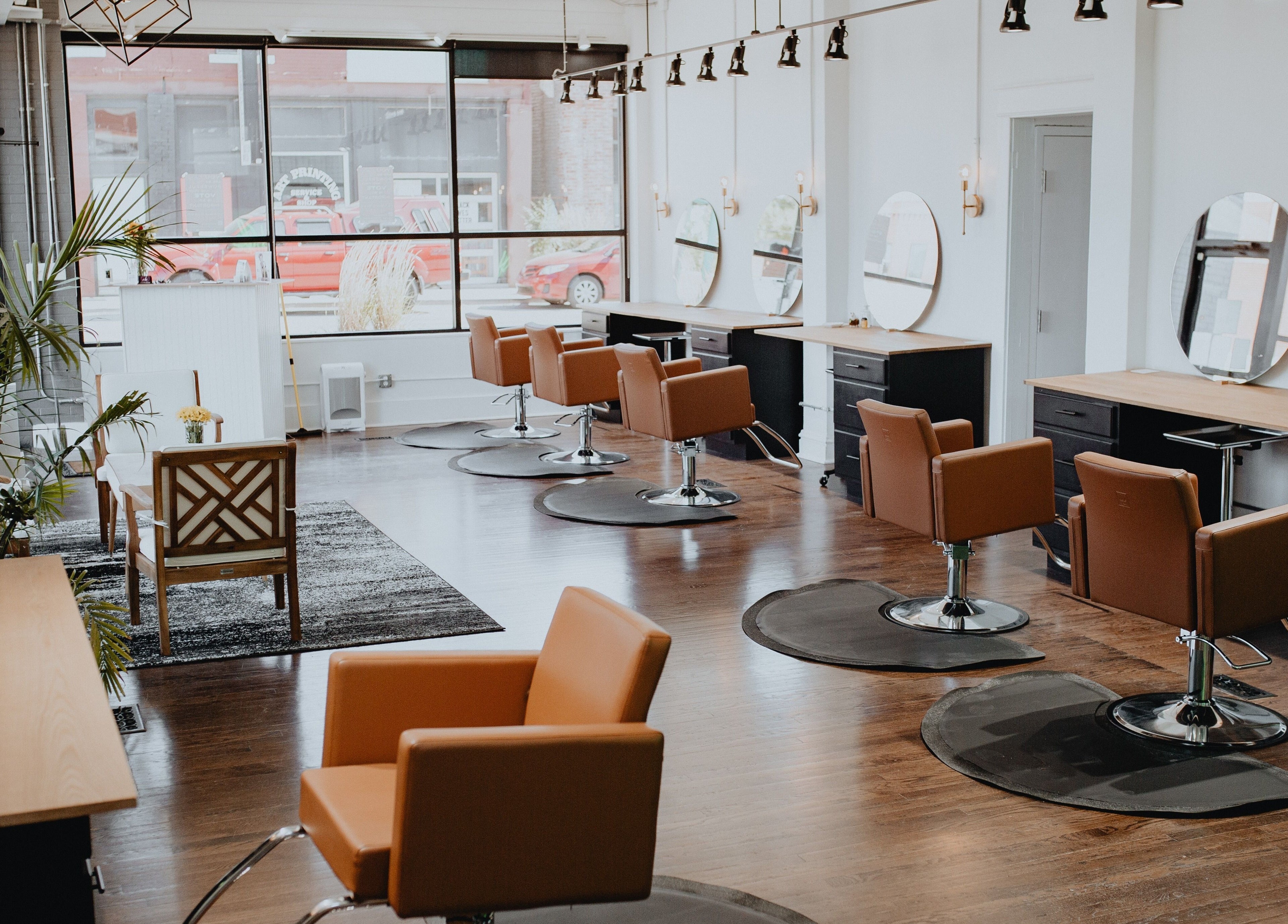 Modern salon interior of Vibe KC in Kansas City, Missouri, US with stylish chairs and mirrors.