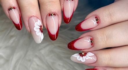Stunning red tipped floral manicure at Tek Nails Sheffield, located in Halfway, England, GB.