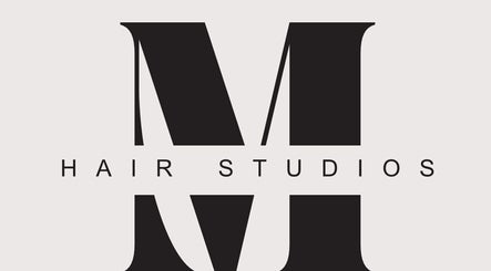 Logo of M Hair Studios in Moreno Valley, California, US featuring large letter M in elegant design.
