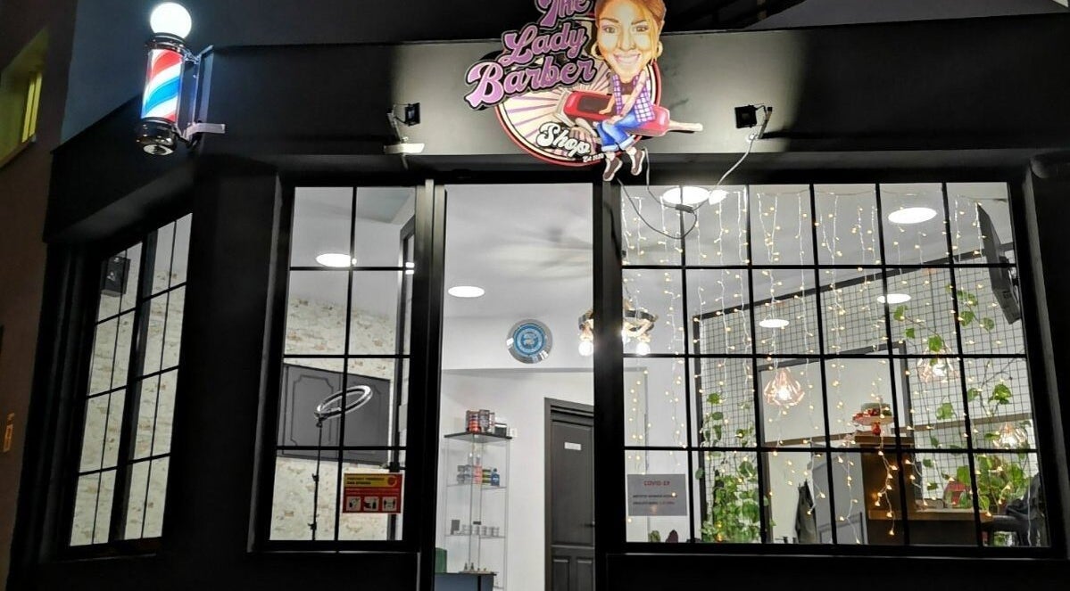 Front view of The Lady Barbershopcy, a chic venue in Limassol, Limassol, CY, featuring stylish glass windows.