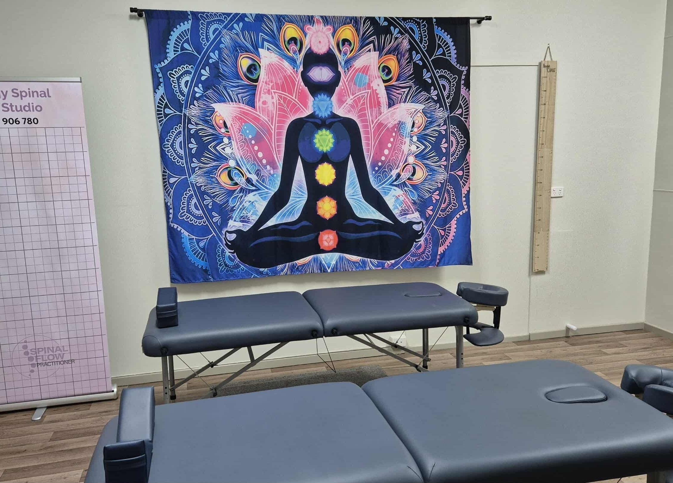 Synergy Spinal Flow Studio therapy room with chakra art in Mareeba, Queensland, AU.
