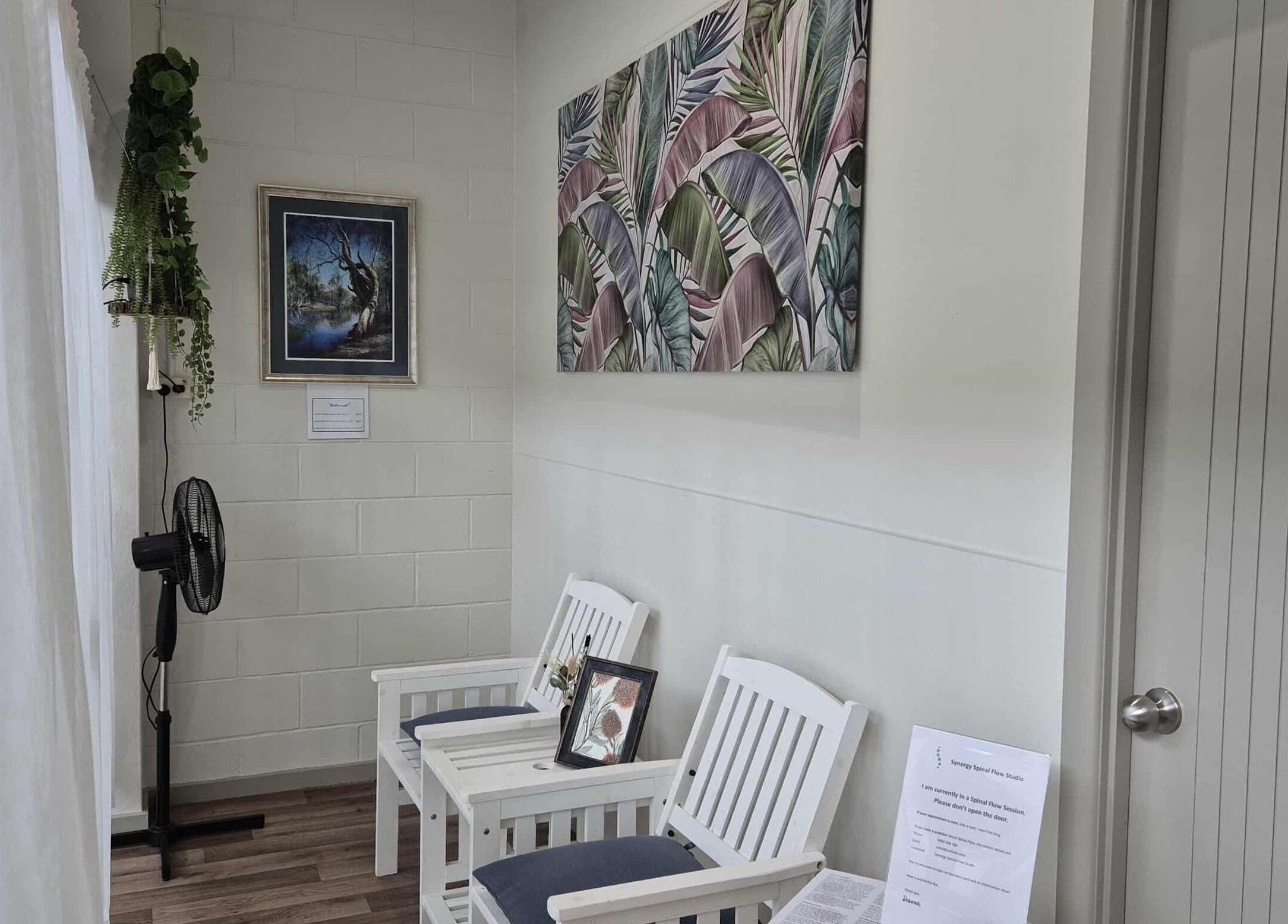 Relaxing seating area at Synergy Spinal Flow Studio, Mareeba, Queensland, AU with artistic decor.