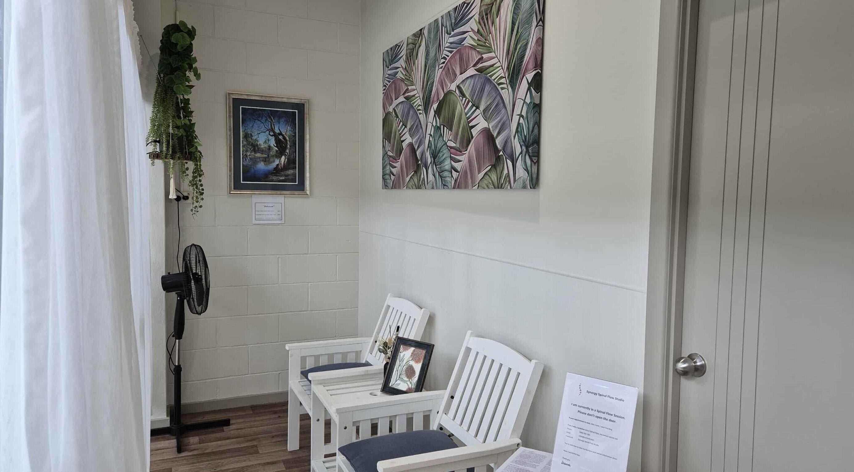 Relaxing seating area at Synergy Spinal Flow Studio, Mareeba, Queensland, AU with artistic decor.