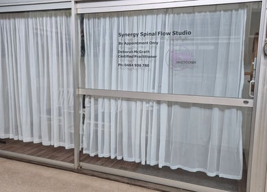 Exterior view of Synergy Spinal Flow Studio in Mareeba, Queensland, AU with white curtains.