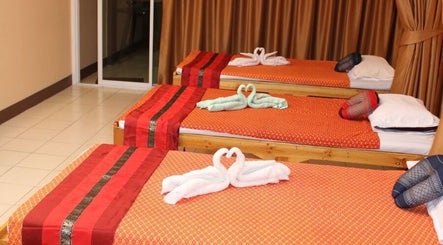 Relaxing massage beds at Kunlarat Massage, Chiang Mai, Chiang Mai, TH, with elegant towel swans.