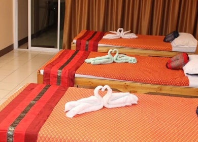 Cozy massage beds with folded towel swans at Kunlarat Massage, Chiang Mai, Chiang Mai, TH.