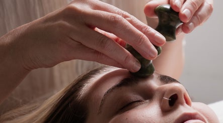 Facial reflexology at Big Calm Reflexology in London, England, GB with a jade stone massage for serene relaxation.