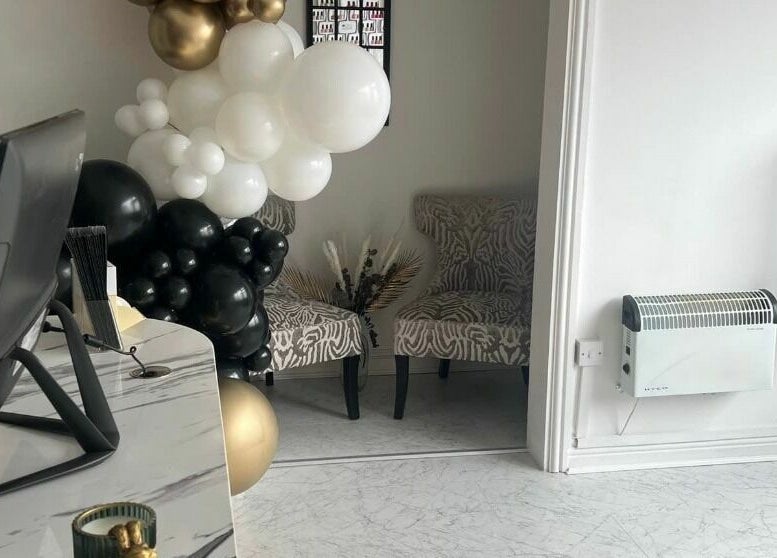 Elegant lounge at Touch of Beauty, Cross Hands, Wales, GB, featuring sophisticated chairs and stylish decor.