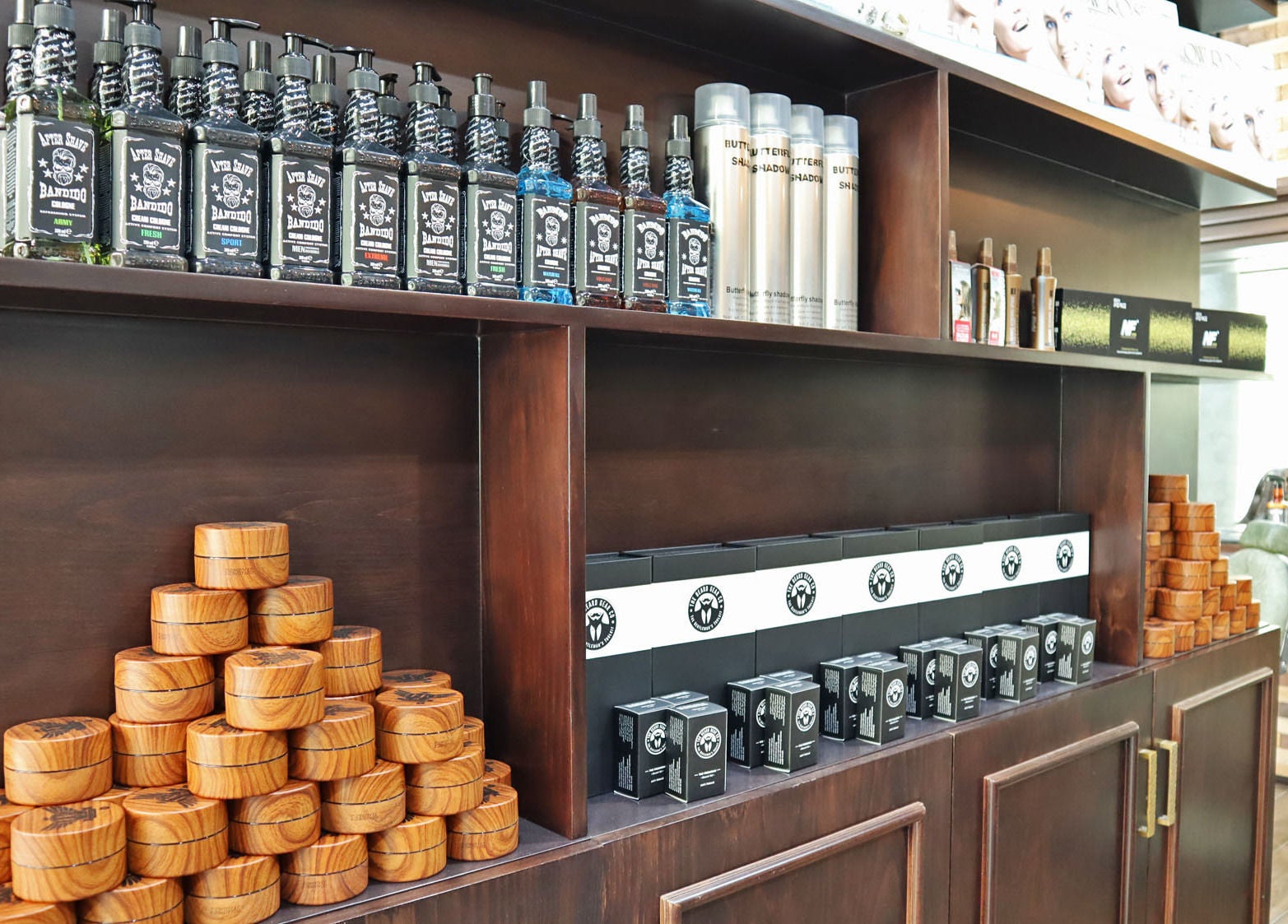Grooming products shelf at Fade & Shave Barbers The Beach, JBR in Dubai, AE showcasing premium items.