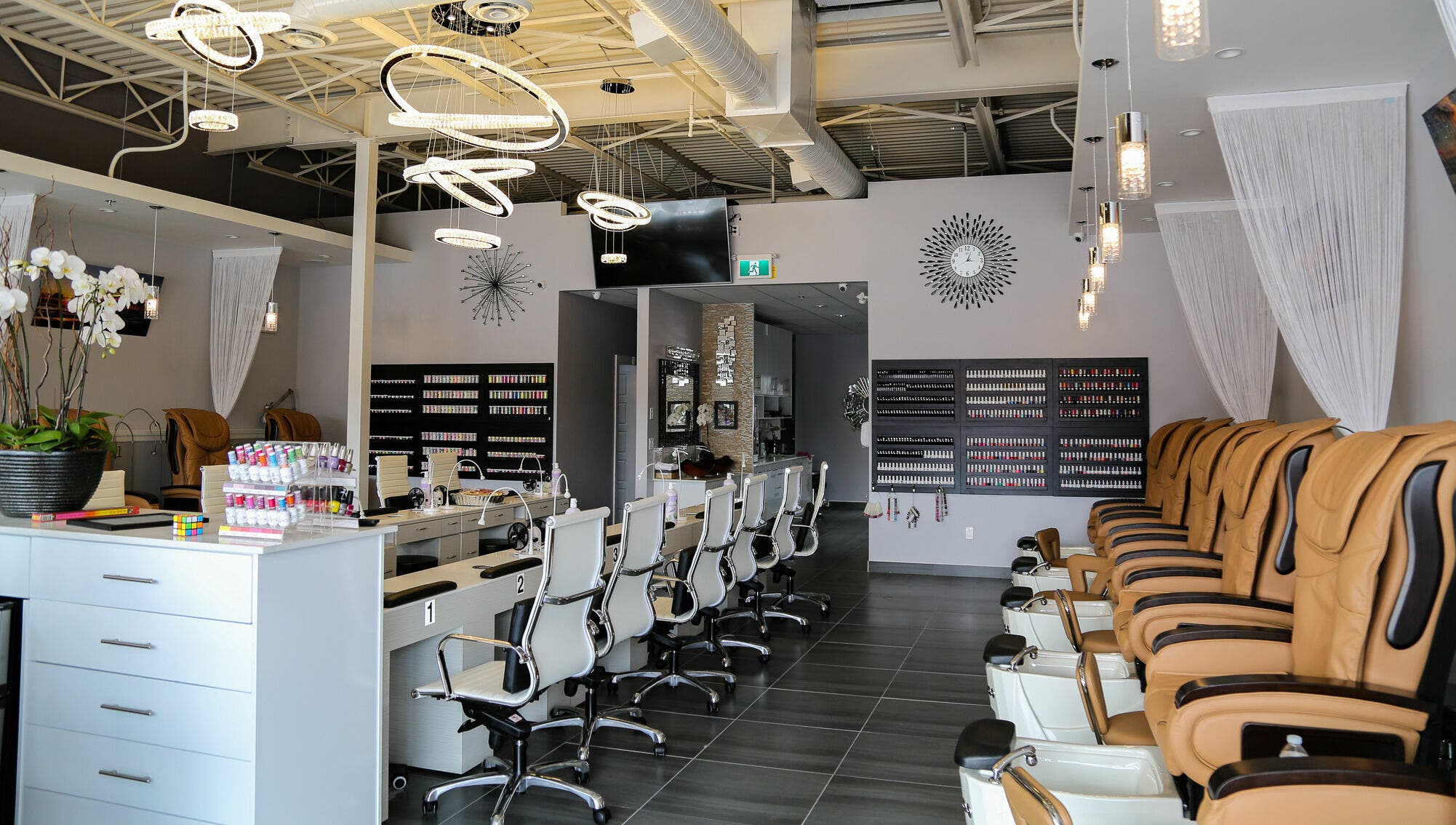 Elegant interior of LTN Nails & Spa in Langley City, British Columbia, CA showcasing chairs and nail polish displays.